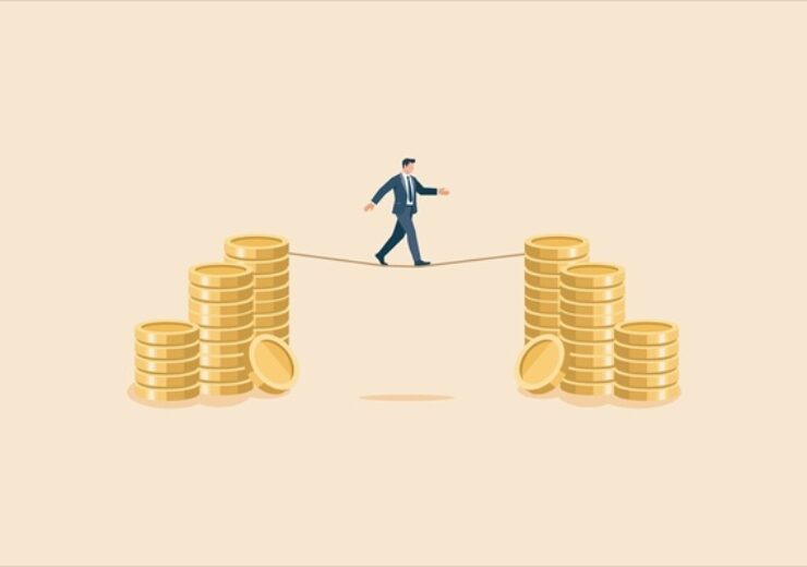 Businessman,Walking,On,A,Tightrope,Between,Piles,Of,Gold,Coins,