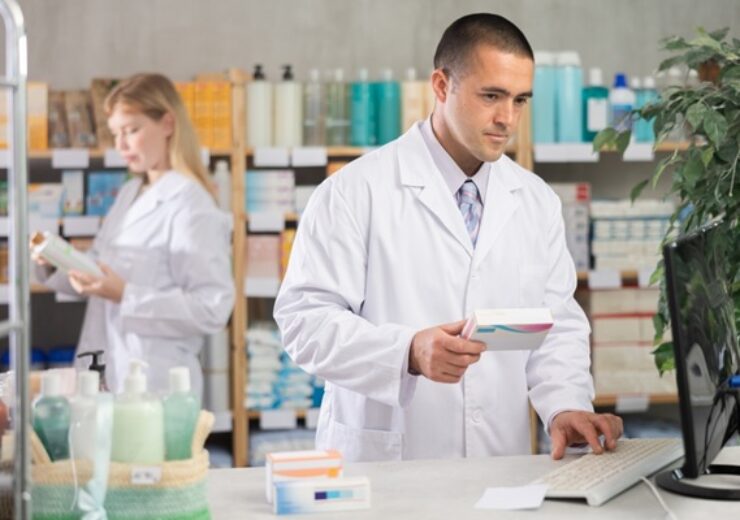 Male,Pharmacist,Holds,A,Package,Of,Pills,In,His,Hands