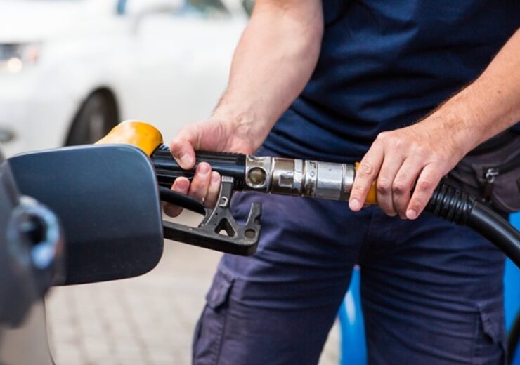 Gas,Station.,Gasoline,Filling,A,Car.,A,Man,Holds,A