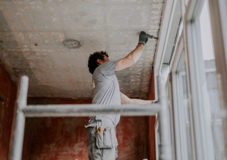 One,Young,Caucasian,Man,Stands,Sideways,On,Scaffolding,And,Uses