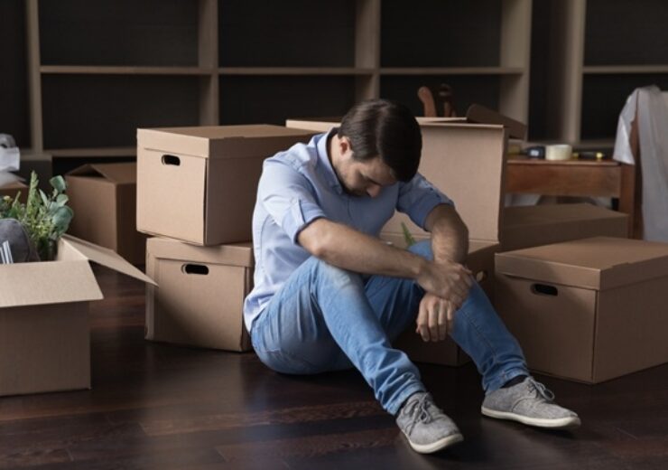 Upset,Frustrated,Man,Sit,On,Floor,Near,Heap,Of,Stacked