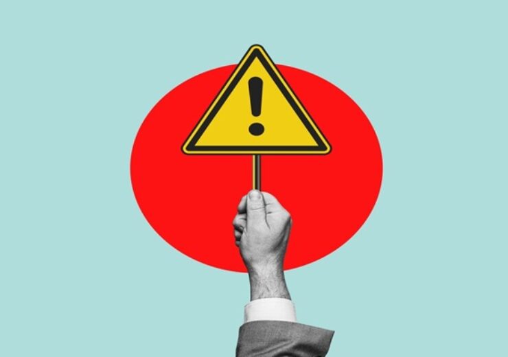 Warning,Sign.,Hand,Holding,A,Warning,Sign,,Alarm,Message,,Caution,