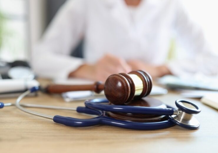 Closeup,Of,Judge,Gavel,Of,Stethoscope,Doctor,In,Background,Writing