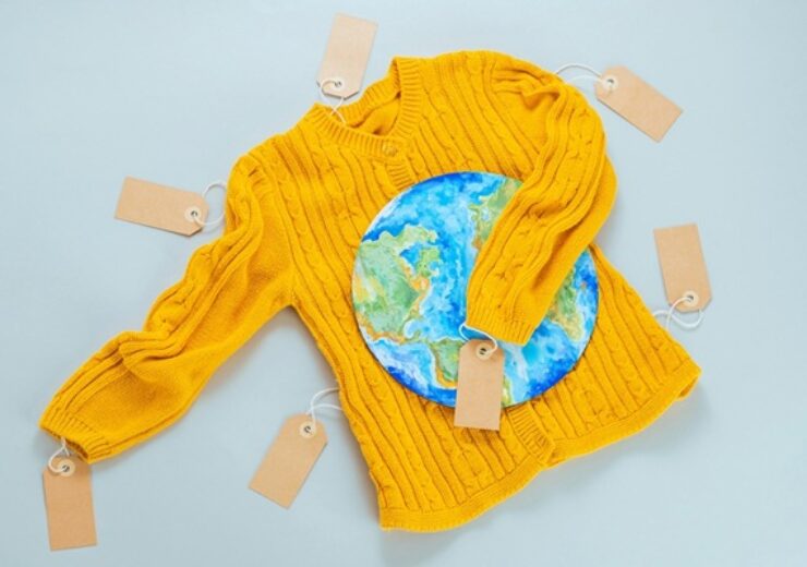 A,Yellow,Knitted,Sweater,With,A,Painted,Planet,Earth,On