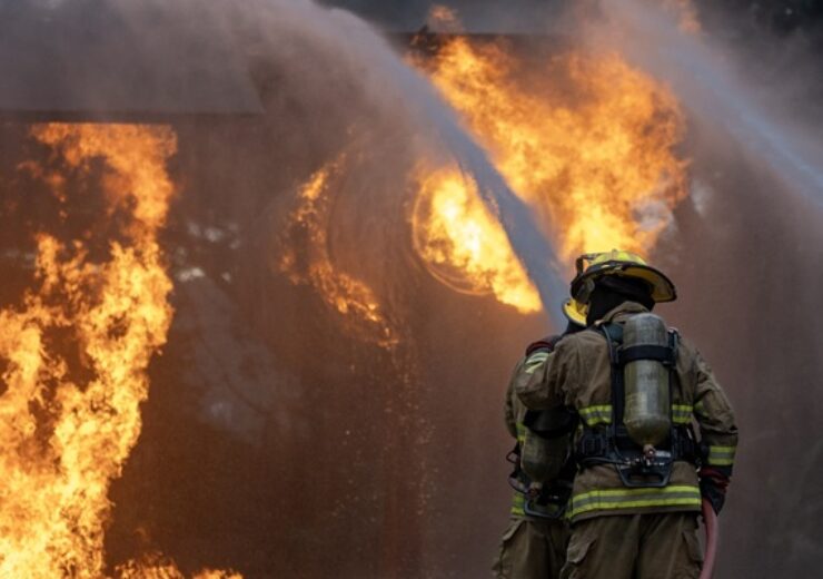 Team,Of,Firefighter,In,Fireproof,Clothe,Using,Twirl,Fog,Watering