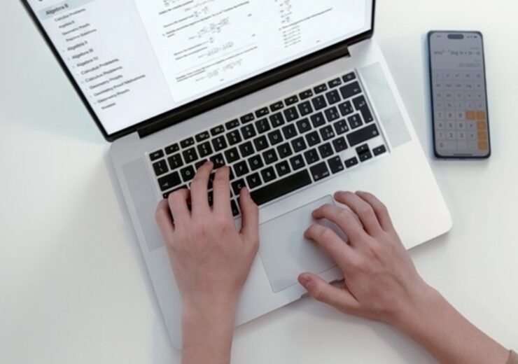 High,Angle,View,Of,Student,Hands,Typing,On,Laptop,Computer
