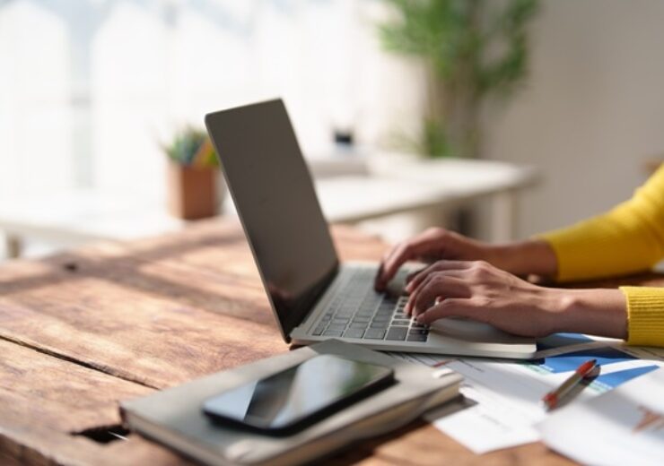 Person,Hands,Wearing,A,Yellow,Sweater,Typing,On,A,Laptop