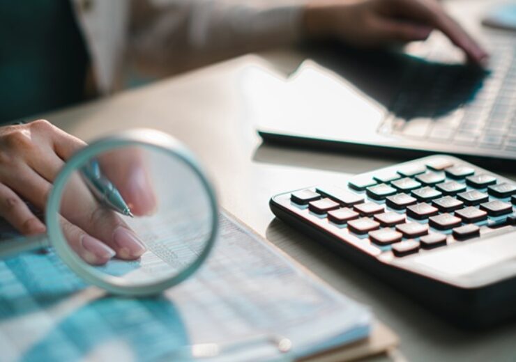 Financial,Documents,With,Calculator,,Pen,And,Magnifying,Glass,On,Desk,