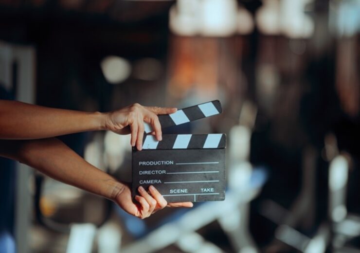 Director,Holding,A,Film,Slate,In,A,Gym,Movie,Set.