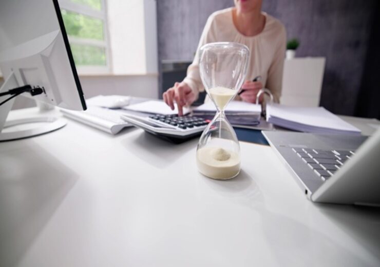 Late,Invoice,And,Billing,Deadline,With,Hourglass,At,Desk