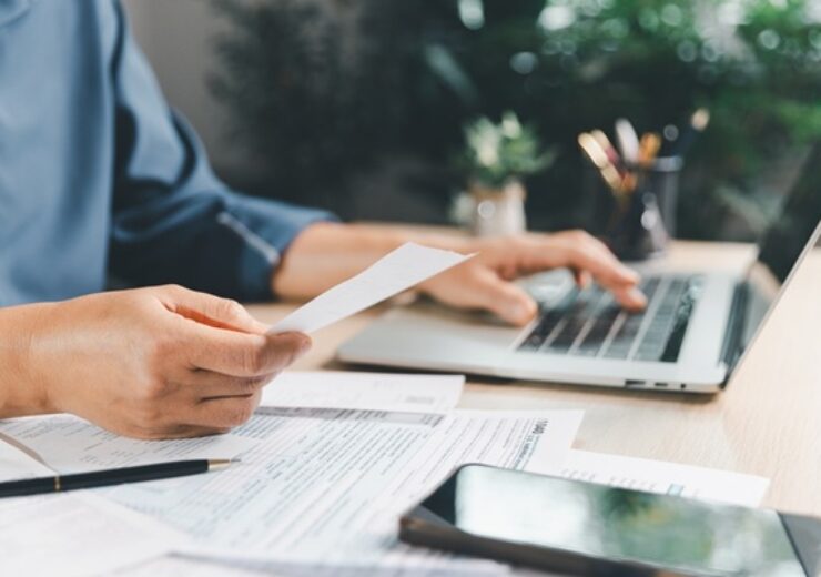 Tax,Preparation,At,Office,Desk,With,Hands,Holding,Receipt,And