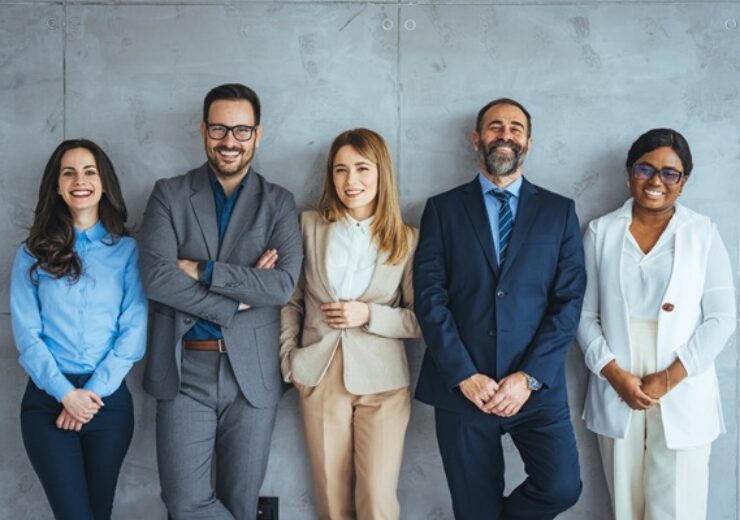 Studio,Portrait,Of,A,Group,Of,Businesspeople,Posing,Against,A
