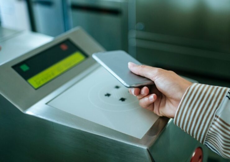 Businesswoman,Using,Her,Smartphone,To,Validate,Electronic,Ticket,At,Automatic